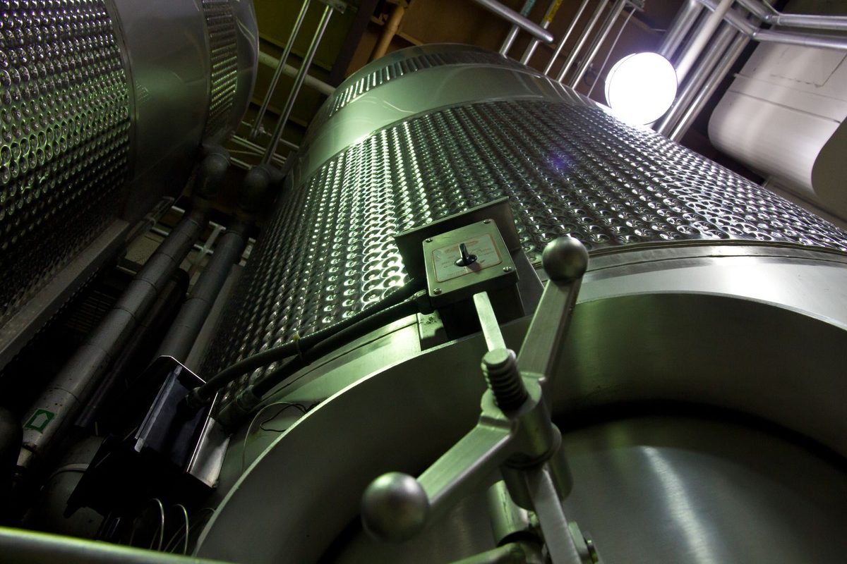 Large stainless-steel tanks in a modern production area (stock photo)